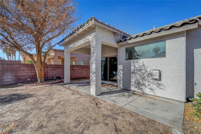 5919 Pavilion Lakes Ave, Las Vegas, NV 89122 - back of property with stucco siding, a patio, and a tile roof
