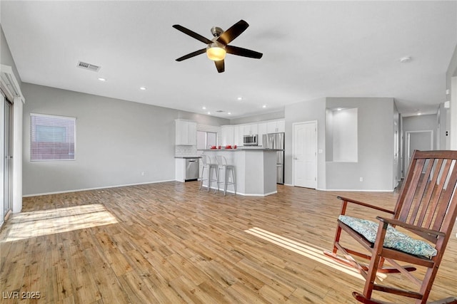 5919 Pavilion Lakes Ave, Las Vegas, NV 89122 - unfurnished living room with a ceiling fan, light wood finished floors, and recessed lighting