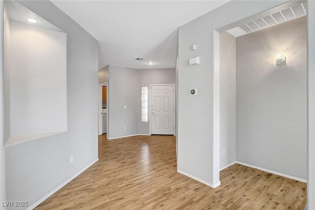 interior space featuring visible vents, baseboards, and light wood-style floors