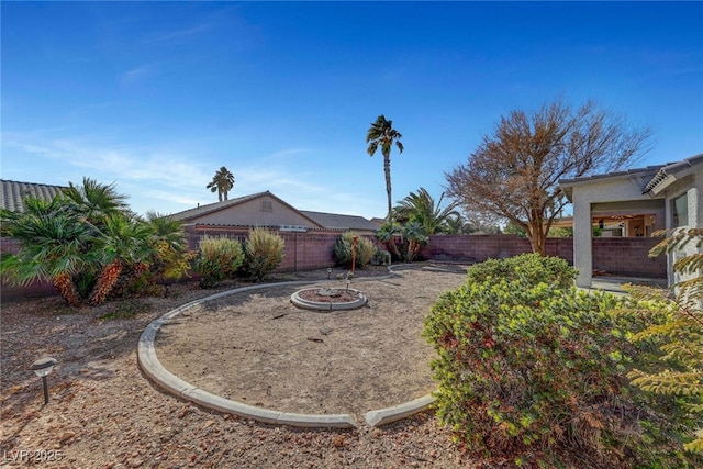 5919 Pavilion Lakes Ave, Las Vegas, NV 89122 - fenced backyard featuring a fire pit