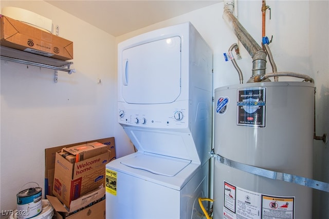 laundry area with gas water heater and stacked washer / dryer