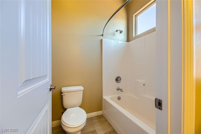 bathroom featuring toilet and shower / bathtub combination