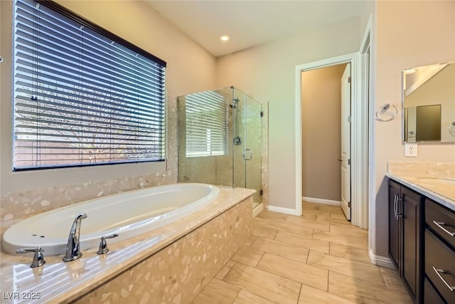 bathroom with plus walk in shower, vanity, and tile patterned flooring