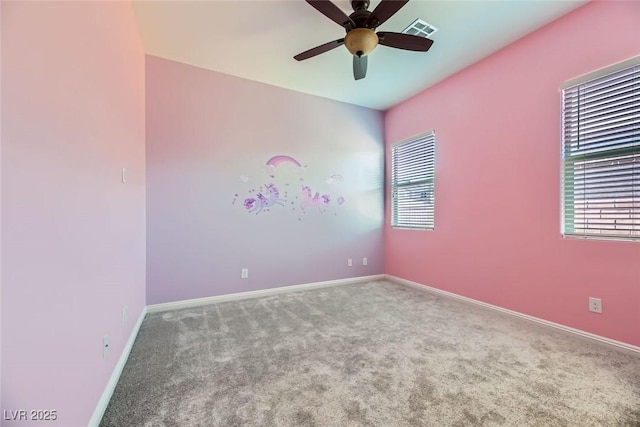 unfurnished room with ceiling fan and carpet floors