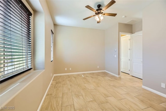 spare room with light wood-type flooring and ceiling fan