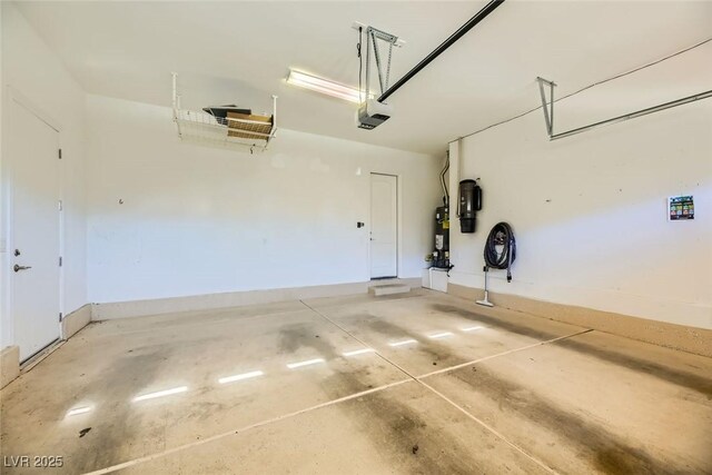 garage featuring a garage door opener and gas water heater