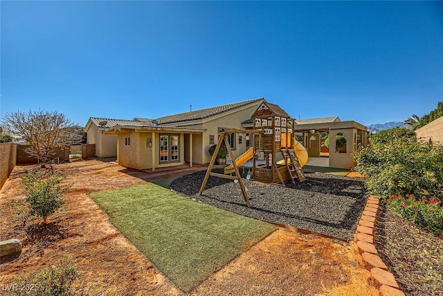 view of jungle gym with french doors