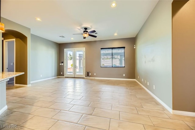 unfurnished room with french doors and ceiling fan