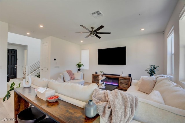 living room featuring light wood-type flooring and ceiling fan