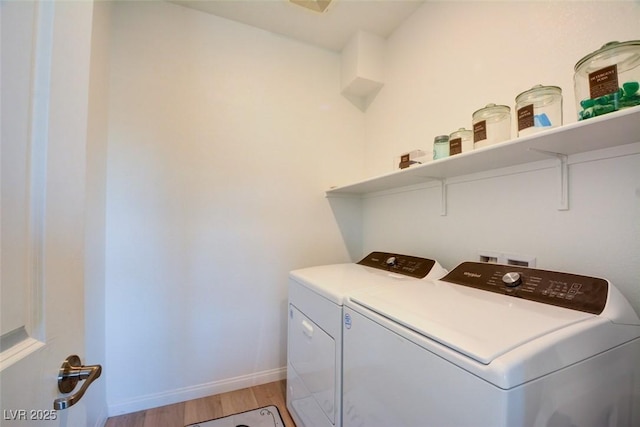 clothes washing area featuring light hardwood / wood-style floors and independent washer and dryer