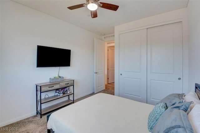 bedroom featuring ceiling fan, light carpet, and a closet