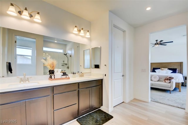 bathroom featuring ceiling fan, vanity, and wood-type flooring