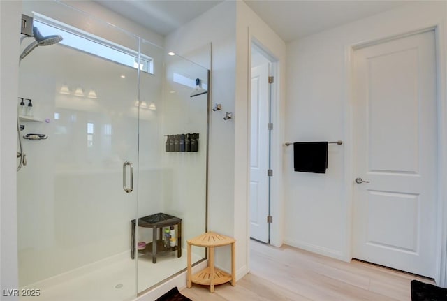 bathroom featuring wood-type flooring and walk in shower