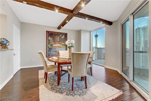 dining area featuring beamed ceiling and dark wood-type flooring