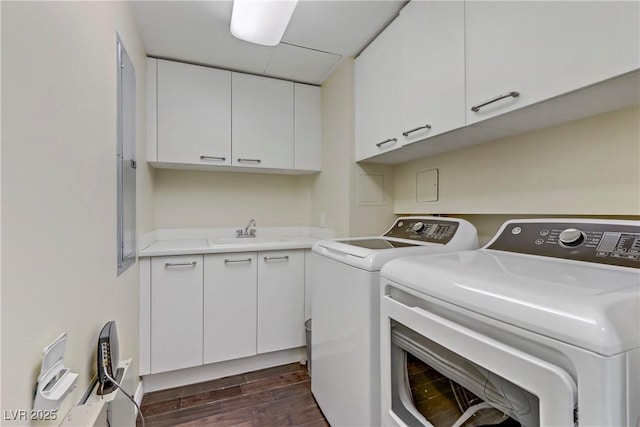 laundry room with cabinets, washing machine and dryer, and sink