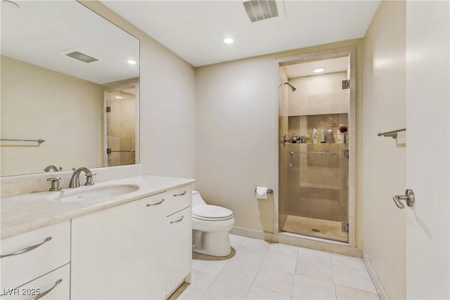 bathroom featuring tile patterned flooring, a shower with door, vanity, and toilet