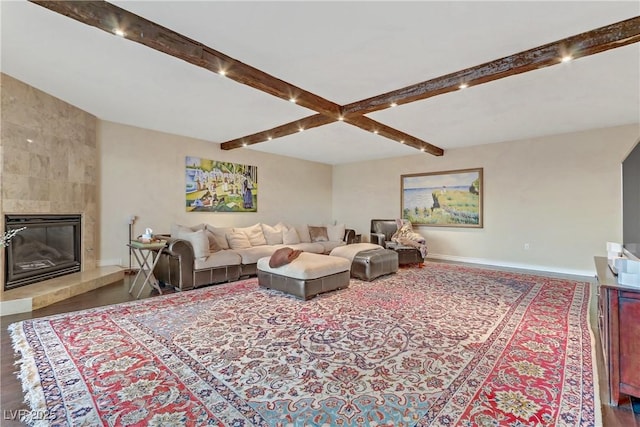 living room with beam ceiling and a fireplace