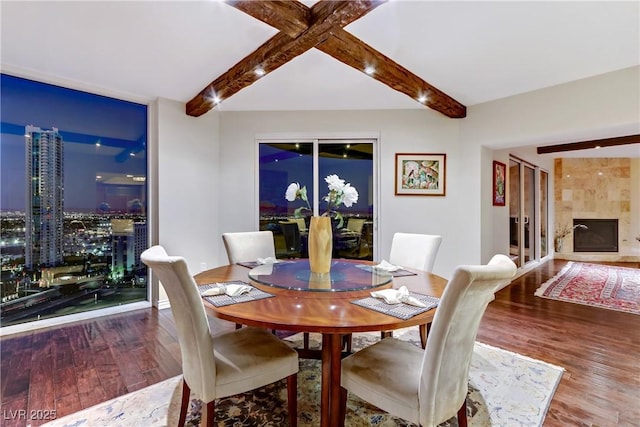 dining space with a high end fireplace and wood-type flooring