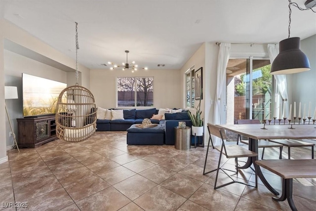 dining room featuring a chandelier and tile patterned floors