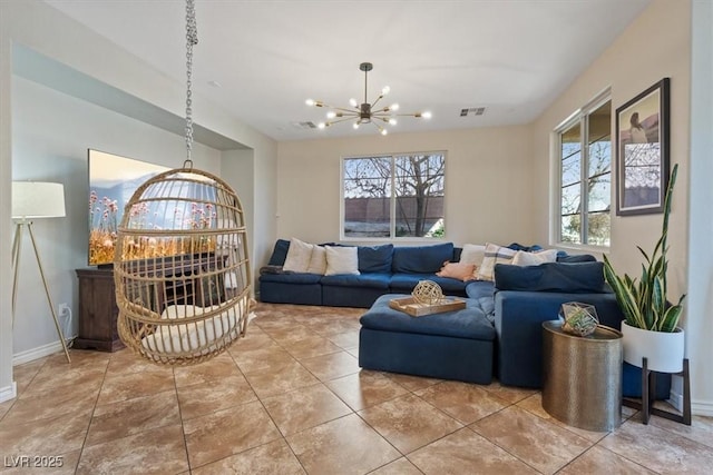 living room featuring tile patterned flooring and an inviting chandelier