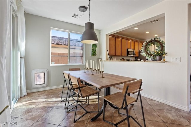 dining room featuring tile patterned flooring and heating unit