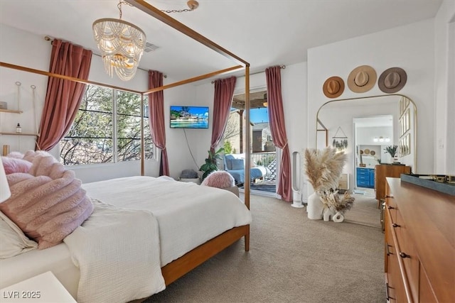 carpeted bedroom featuring access to exterior and an inviting chandelier