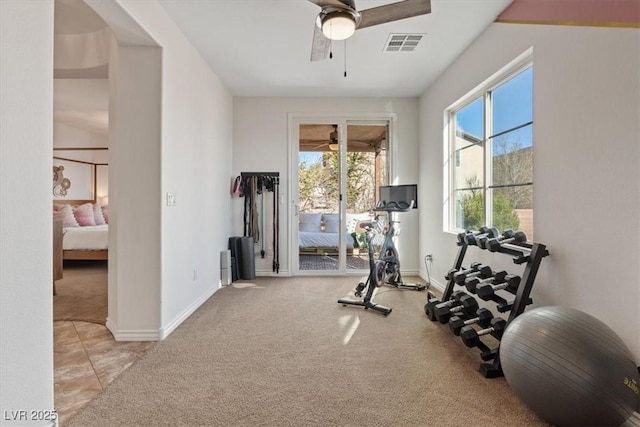 workout room featuring ceiling fan and light carpet