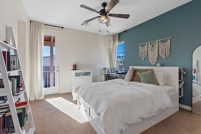 bedroom with multiple windows, ceiling fan, and carpet