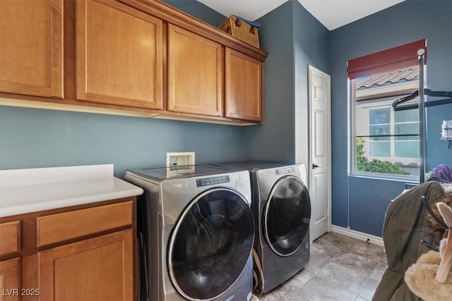 laundry room featuring cabinets and independent washer and dryer