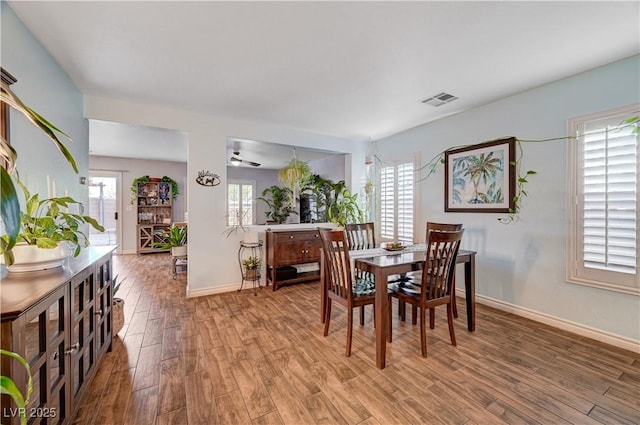 dining space with wood-type flooring