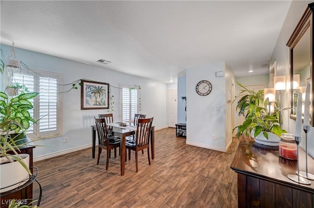 dining space featuring dark hardwood / wood-style flooring and a wealth of natural light