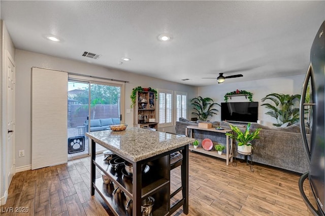 kitchen featuring stainless steel refrigerator and ceiling fan