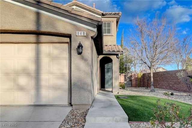 view of exterior entry with a garage