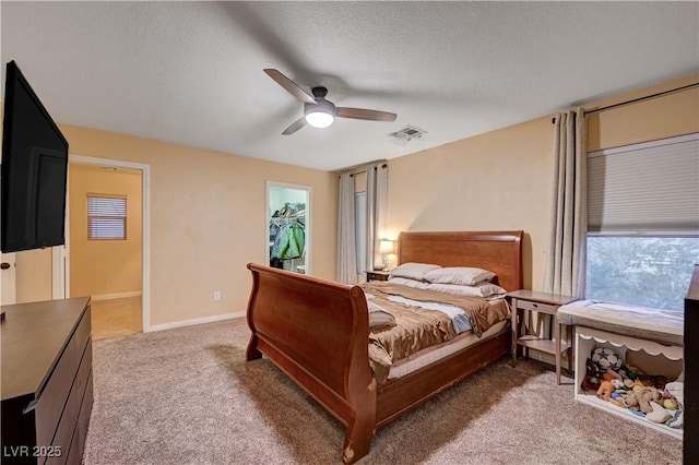 bedroom featuring a textured ceiling, carpet floors, and ceiling fan