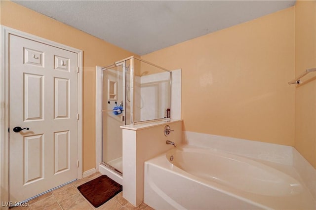 bathroom featuring tile patterned floors and separate shower and tub