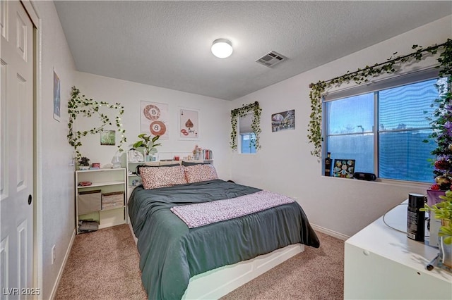 carpeted bedroom featuring a textured ceiling