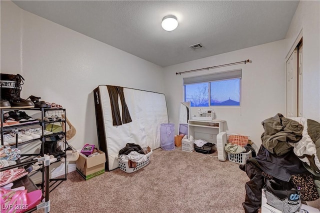 playroom featuring carpet and a textured ceiling