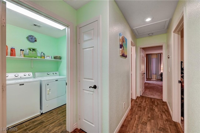 laundry area featuring dark hardwood / wood-style flooring and washing machine and dryer