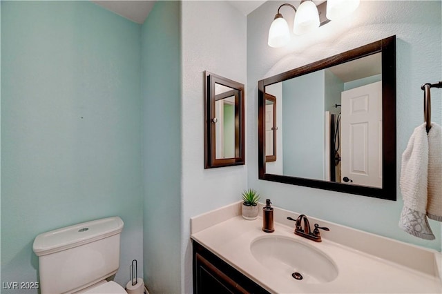 bathroom featuring vanity and toilet