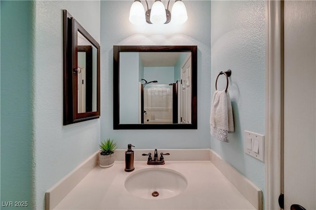 bathroom with vanity and a shower