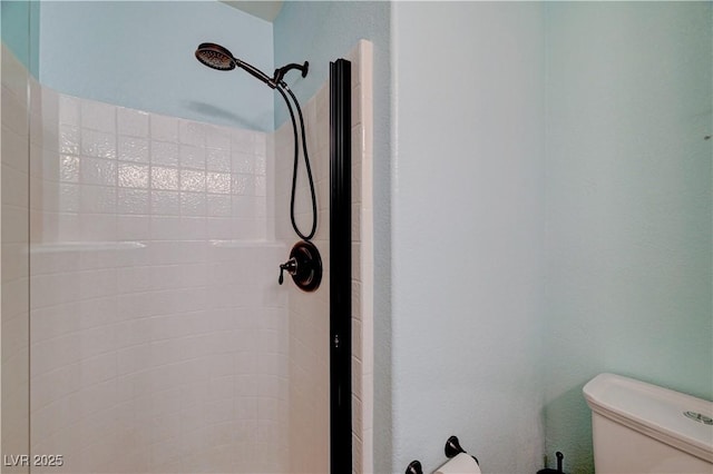 bathroom featuring toilet and walk in shower