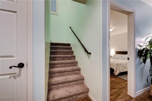 staircase with hardwood / wood-style floors