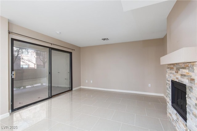 unfurnished living room with light tile patterned floors and a fireplace