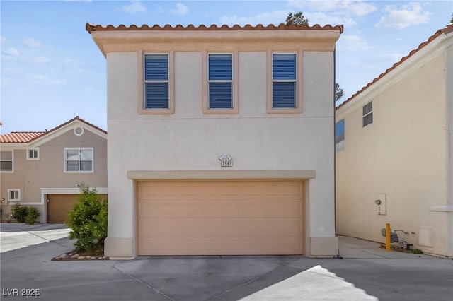 mediterranean / spanish-style house with a garage