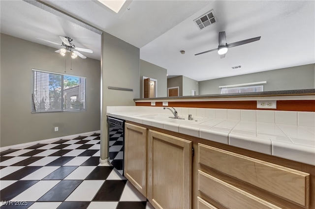 kitchen featuring light brown cabinetry, tile countertops, beverage cooler, and sink