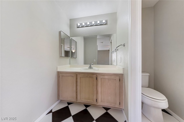 bathroom featuring vanity and toilet