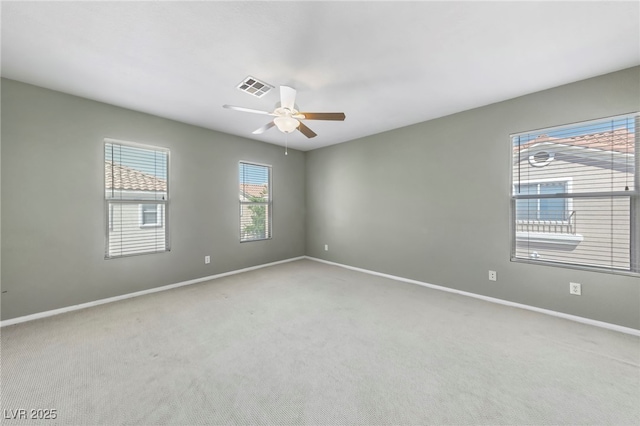 empty room with ceiling fan and carpet floors