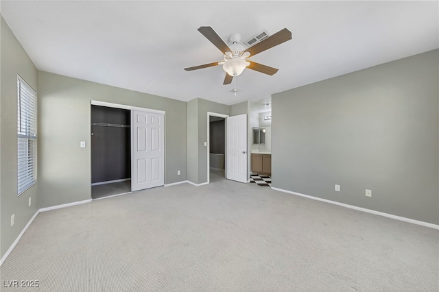 unfurnished bedroom with ceiling fan, a closet, and light carpet