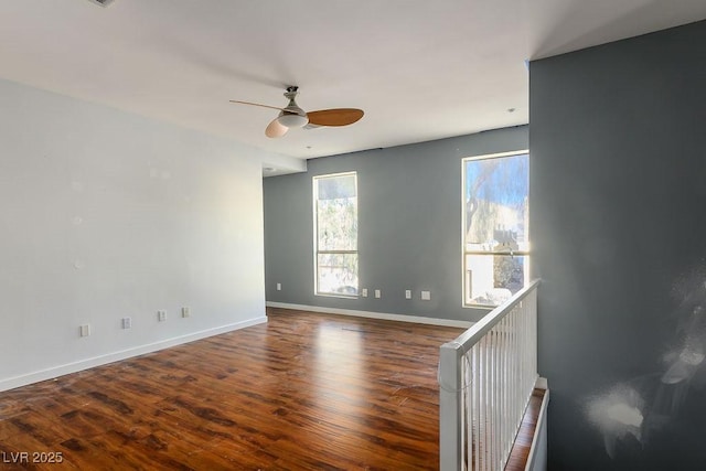 empty room with hardwood / wood-style floors and ceiling fan