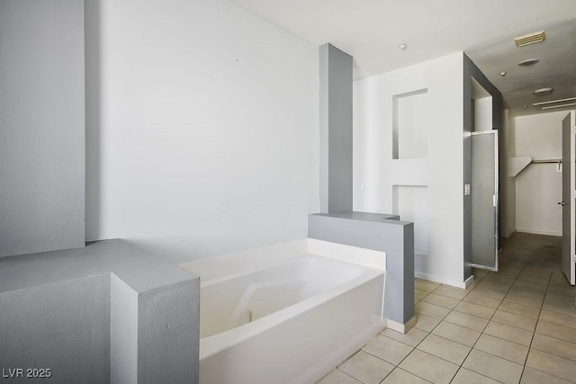 bathroom featuring tile patterned floors and a bathing tub